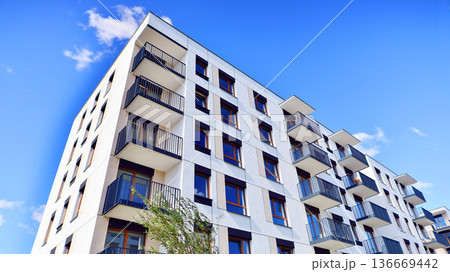 Residential building. bottom view. Modern apartment building on a sunny day. Facade of a modern apartment building. Residential building. bottom view. Modern apartment building on a sunny day. Facade of a modern apartment building. 136669442