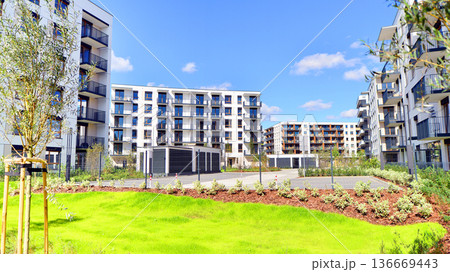 Residential building. bottom view. Modern apartment building on a sunny day. Facade of a modern apartment building. Residential building. bottom view. Modern apartment building on a sunny day. Facade of a modern apartment building. 136669443