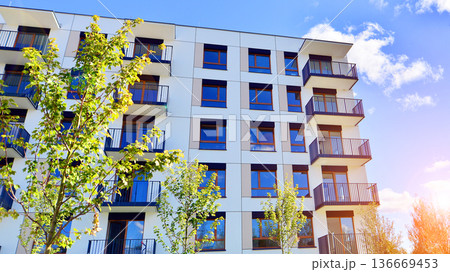 Residential building. bottom view. Modern apartment building on a sunny day. Facade of a modern apartment building. Residential building. bottom view. Modern apartment building on a sunny day. Facade of a modern apartment building. 136669453