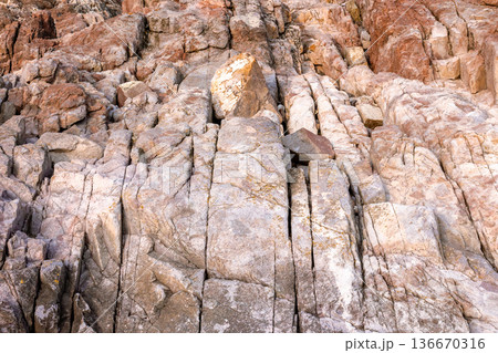 closeup of coast rock texture. rough stone background from the black sea in summer. detail of bulgaria rugged shore. backdrop for material design 136670316