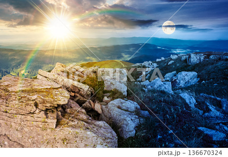 rocky formations on a grassy hill. day and night time change concept. wonderful mountain landscape in august with sun and moon. alpine scenery on a cloudy weather. spectacular view in to the distance rocky formations on a grassy hill. day and night time change concept. wonderful mountain landscape in august with sun and moon. alpine scenery on a cloudy weather. spectacular view in to the distance 136670324