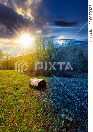 mountain landscape with green grass on forest glade in spring. day and night time change concept. beautiful nature scenery with beech trees under sky with sun and moon. equality and shift template 136670325