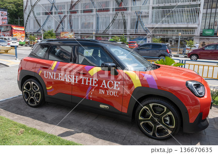New promotional Mini Cooper vehicle display in Penang with bright graphics attracting customer interest New promotional Mini Cooper vehicle display in Penang with bright graphics attracting customer interest 136670635