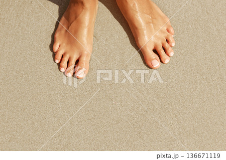 Female legs on beach. top view Female legs on beach. top view 136671119