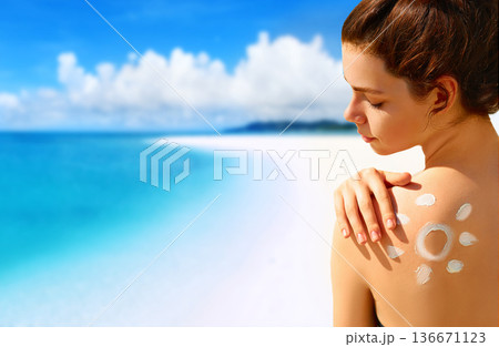 Portrait of gorgeous woman in bikini with the drawn sun on a shoulder at beach Portrait of gorgeous woman in bikini with the drawn sun on a shoulder at beach 136671123