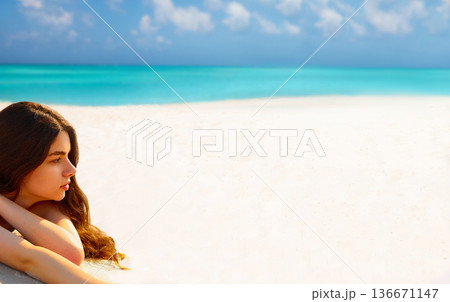 Portrait of beautiful woman while relaxing on beach Portrait of beautiful woman while relaxing on beach 136671147