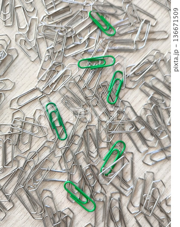 Individuality in a crowd: the concept of uniqueness, green paper clips stand out among silver ones 136671509