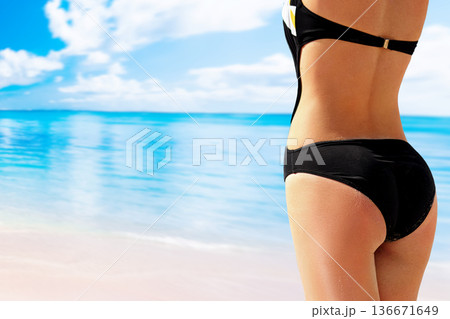 Portrait of woman having pretty bottom in bikini 136671649
