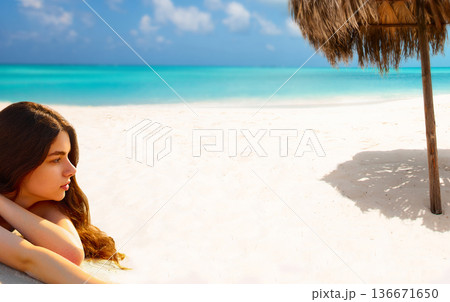 Portrait of gorgeous young woman while relaxing on beach Portrait of gorgeous young woman while relaxing on beach 136671650