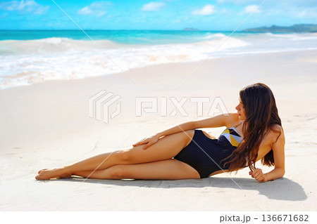 Portrait of gorgeous young woman apply sun protection cream on her smooth tanned legs Portrait of gorgeous young woman apply sun protection cream on her smooth tanned legs 136671682