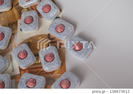 Cleaning supply expense: dishwasher tablets placed directly on euro banknotes 136673612