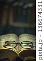 reading eyeglasses lying on open book page in university library or school, intelligence and education, study and learning concept 136674331