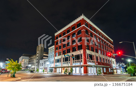 Historic red brick building in downtown Jackson, Mississippi. Features arched windows and white cornice at the corner of Capitol Street and Congress Street at night 136675184