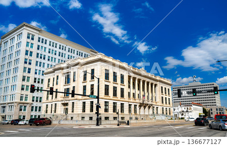 Memorial Hall in Topeka, Kansas. Historic Neoclassical government architecture features a grand limestone facade with Corinthian columns under a bright blue sky 136677127