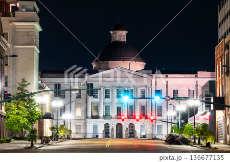 Old Mississippi State Capitol Museum in Jackson. Historic Greek Revival architecture features a dome and columned portico viewed from East Capitol Street at night 136677135