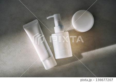 Minimalist white skincare cosmetic products set on concrete 136677207