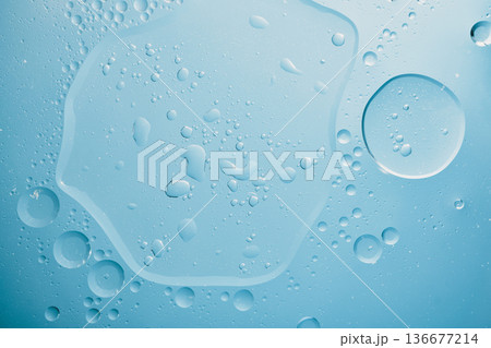 Close up view of water and oil creating an abstract blue texture Close up view of water and oil creating an abstract blue texture 136677214