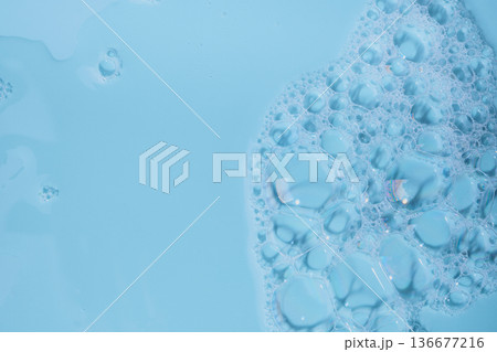 Blue liquid with transparent soap foam texture and abstract bubbles Blue liquid with transparent soap foam texture and abstract bubbles 136677216