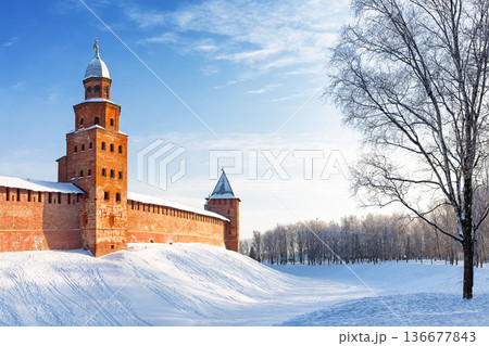 The Kokuy Tower of the Novgorod Kremlin on a cold winter day in Veliky Novgorod, Russia. The Kremlin wall in Veliky Novgorod during a frosty winter sunset. The Kokuy Tower of the Novgorod Kremlin on a cold winter day in Veliky Novgorod, Russia. The Kremlin wall in Veliky Novgorod during a frosty winter sunset. 136677843