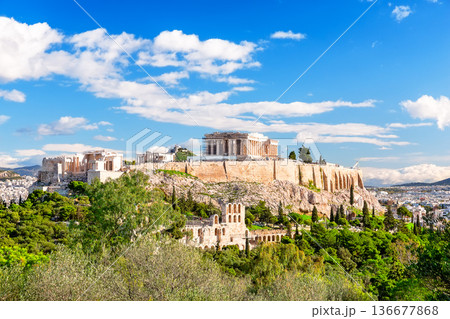 The Acropolis of Athens with the Parthenon Temple in sunny day, Greece. View of the ruins of the ancient city of Athens in Greece. The Acropolis of Athens with the Parthenon Temple in sunny day, Greece. View of the ruins of the ancient city of Athens in Greece. 136677868