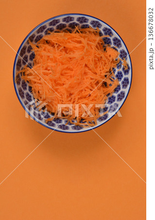 Grated Carrots in Ceramic Bowl 136678032