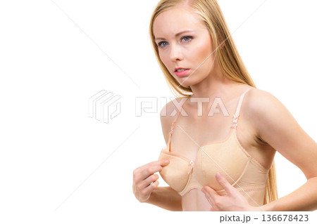 Girl wearing too big bra cup Girl wearing too big bra cup 136678423