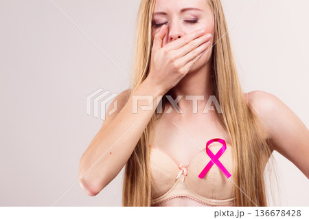 Woman pink cancer ribbon on breast 136678428
