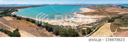 Panoramic aerial view of Salada de la Mata lagoon in Torrevieja, Spain. Young vineyards on the lake shore on a sunny day Panoramic aerial view of Salada de la Mata lagoon in Torrevieja, Spain. Young vineyards on the lake shore on a sunny day 136678623