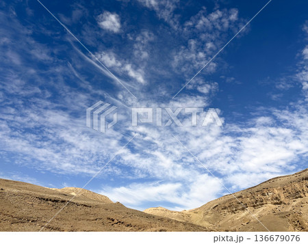 Eilat Mountains desert landscape with layered sedimentary cliffs and dramatic sky Eilat Mountains desert landscape with layered sedimentary cliffs and dramatic sky 136679076