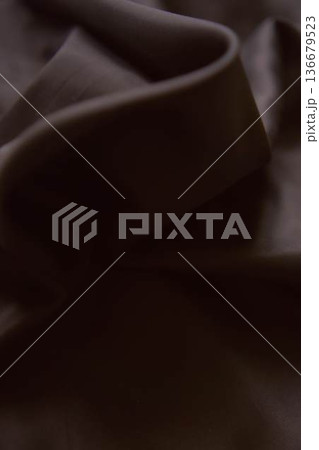 Elegant dark chocolate brown silk fabric with smooth satin ripples Elegant dark chocolate brown silk fabric with smooth satin ripples 136679523