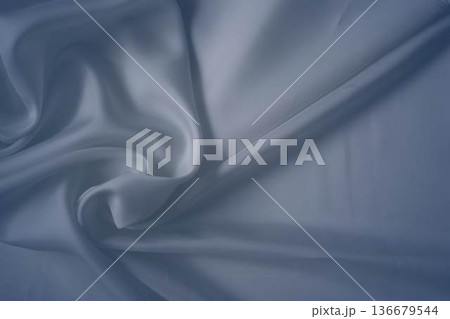 White and cashmere blue silk fabric with elegant flowing folds White and cashmere blue silk fabric with elegant flowing folds 136679544