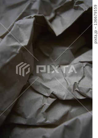 Crumpled brown kraft paper texture with rough fold Crumpled brown kraft paper texture with rough fold 136679559