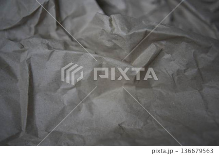 Crumpled brown kraft paper texture with rough fold Crumpled brown kraft paper texture with rough fold 136679563