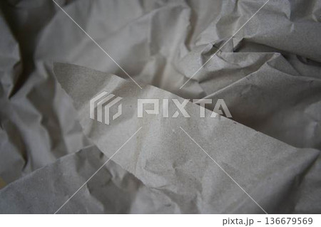 Crumpled brown kraft paper texture with rough fold Crumpled brown kraft paper texture with rough fold 136679569