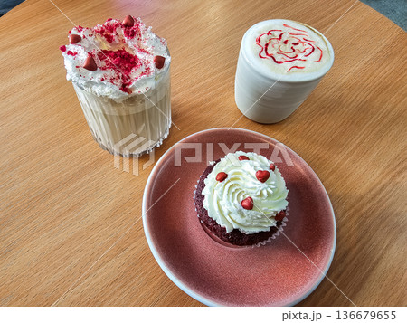 Latte and Cappuccino with Muffin on Table Horizontal 136679655