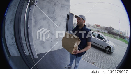 Male Courier Ringing Bell and Leaving an Order at Door Male Courier Ringing Bell and Leaving an Order at Door 136679697