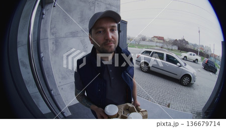 Adult Man Speaks Through Smart Doorbell Before Client Exits Pay Contactless Via Smartphone 136679714