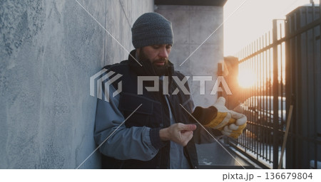 Man Leaning Against Wall Catch Breath After Intense Work Man Leaning Against Wall Catch Breath After Intense Work 136679804
