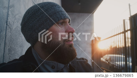 After Heavy Snow Shoveling, Worker Pauses to Recover, Lifting Face Toward Fading Sunlight After Heavy Snow Shoveling, Worker Pauses to Recover, Lifting Face Toward Fading Sunlight 136679865