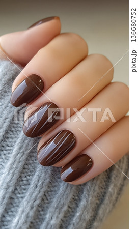 Chocolate Nails With a Knitted Sweater in a Soft Indoor Setting During Daytime Hours 136680752