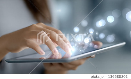 Closeup of Hands Interacting With a Tablet at Home While Using Modern Technology During Daytime Closeup of Hands Interacting With a Tablet at Home While Using Modern Technology During Daytime 136680801