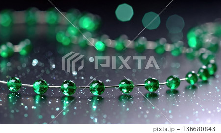 Closeup View of Green Beads Moving Smoothly in Slow Motion With Bokeh Background in Soft Light Closeup View of Green Beads Moving Smoothly in Slow Motion With Bokeh Background in Soft Light 136680843