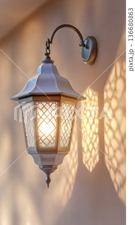 Closeup View of Illuminated Traditional Lantern Casting Patterns on the Wall During Evening Hours 136680863