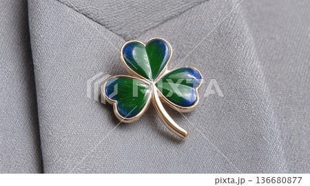 Closeup View of a Shamrock Pin Attached to a Gray Jacket During a Festive Celebration 136680877