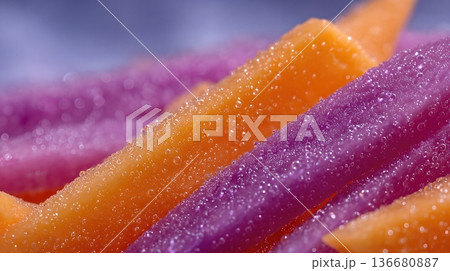 Closeup of Washed Purple and Orange Vegetable Strips Showing Textures and Water Droplets Closeup of Washed Purple and Orange Vegetable Strips Showing Textures and Water Droplets 136680887