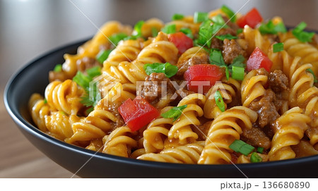 Closeup of Cooked Pasta With Meat and Vegetables in a Black Bowl on a Wooden Table Closeup of Cooked Pasta With Meat and Vegetables in a Black Bowl on a Wooden Table 136680890