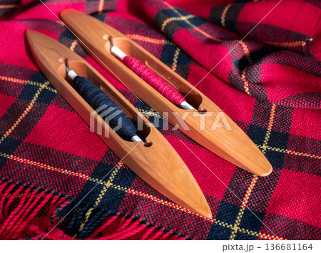 Handwoven fabric showcasing traditional craftsmanship and weaving tools. This vibrant textile is a testament to the artistry of handmade weaving 136681164