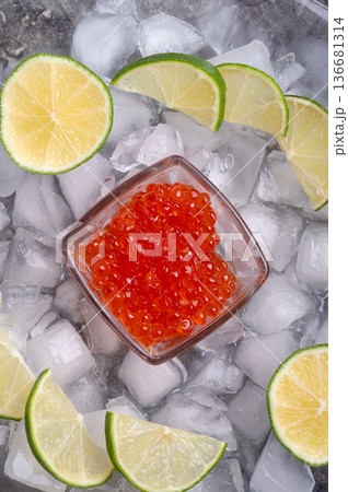 fresh red  salmon caviar with lime around ice. macro shot.  Protein luxury delicacy  healthy food. close up. flat lay 136681314