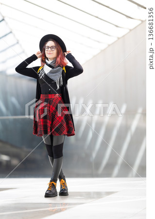 Young woman confidently posing urban modern background 136681356