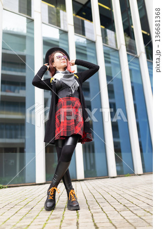 Young woman showing alternative street style fashion in city Young woman showing alternative street style fashion in city 136681368